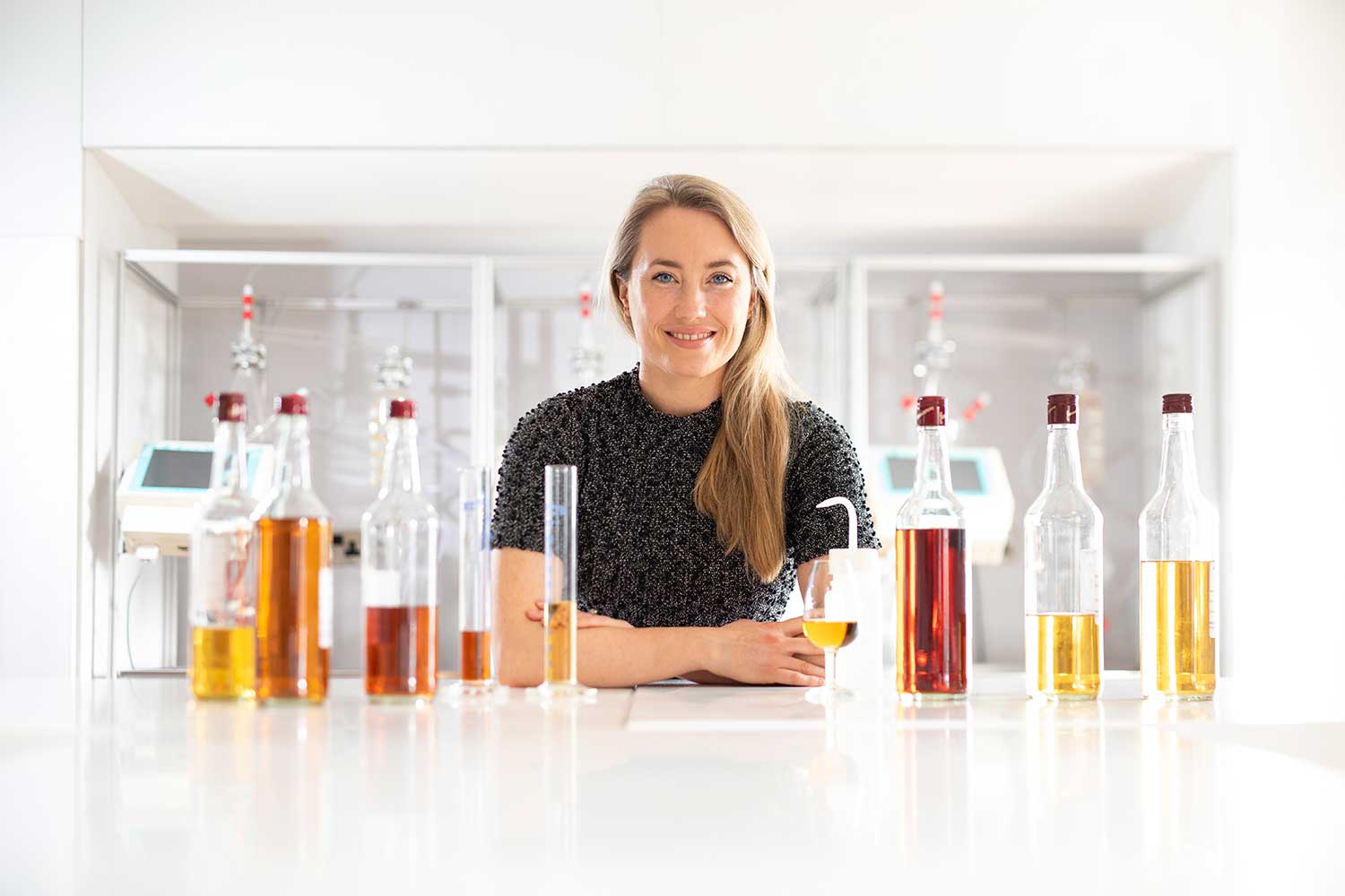 deirdre ocarroll idl blender sitting in the lab surrounded by a variety of Irish whiskey samples