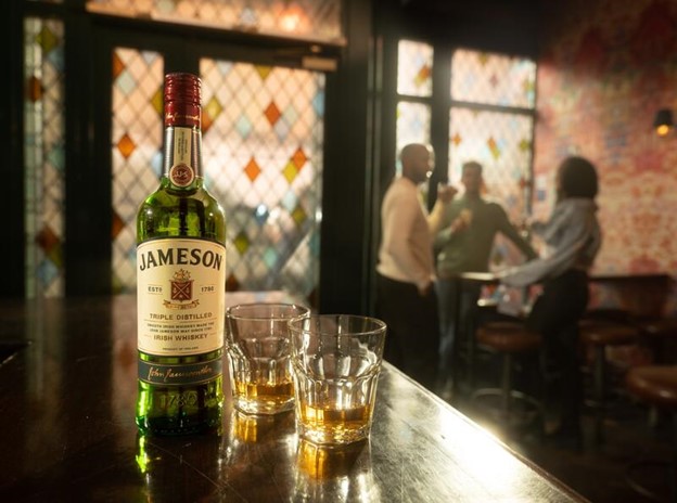 perfectly preserved jameson irish whiskey bottle alongside two servings of whiskey.