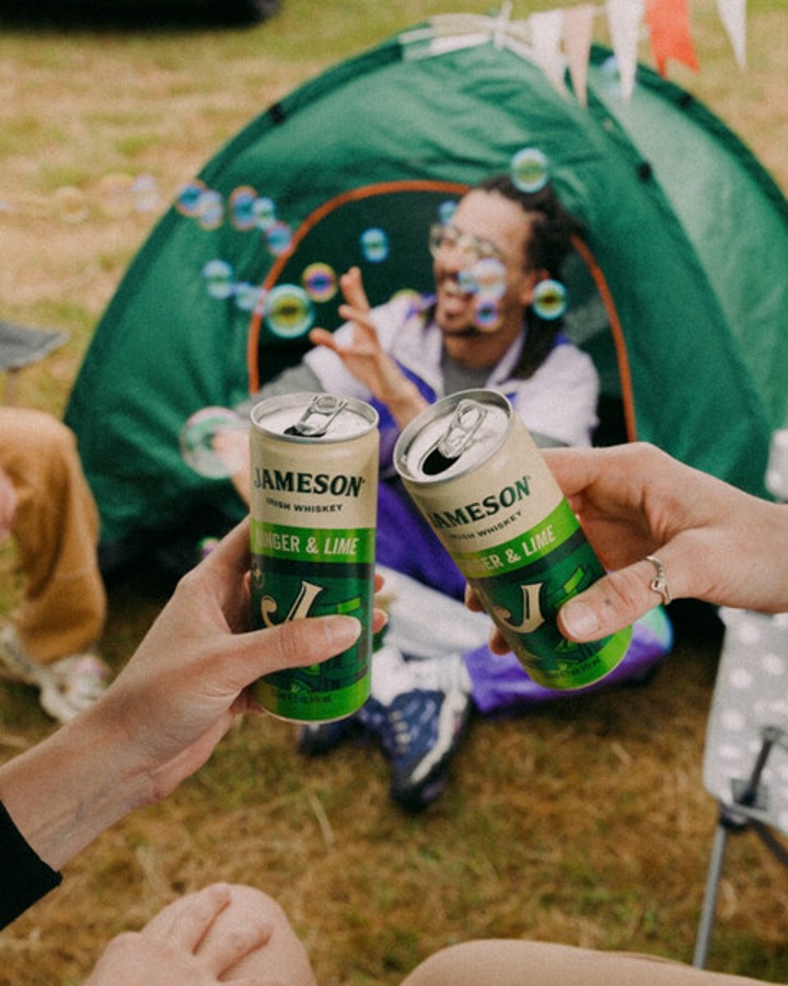 two friends doing a cheers with their Ready to Drink Cans at a Festival