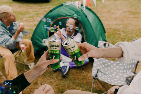 friends doing a cheers at a festival